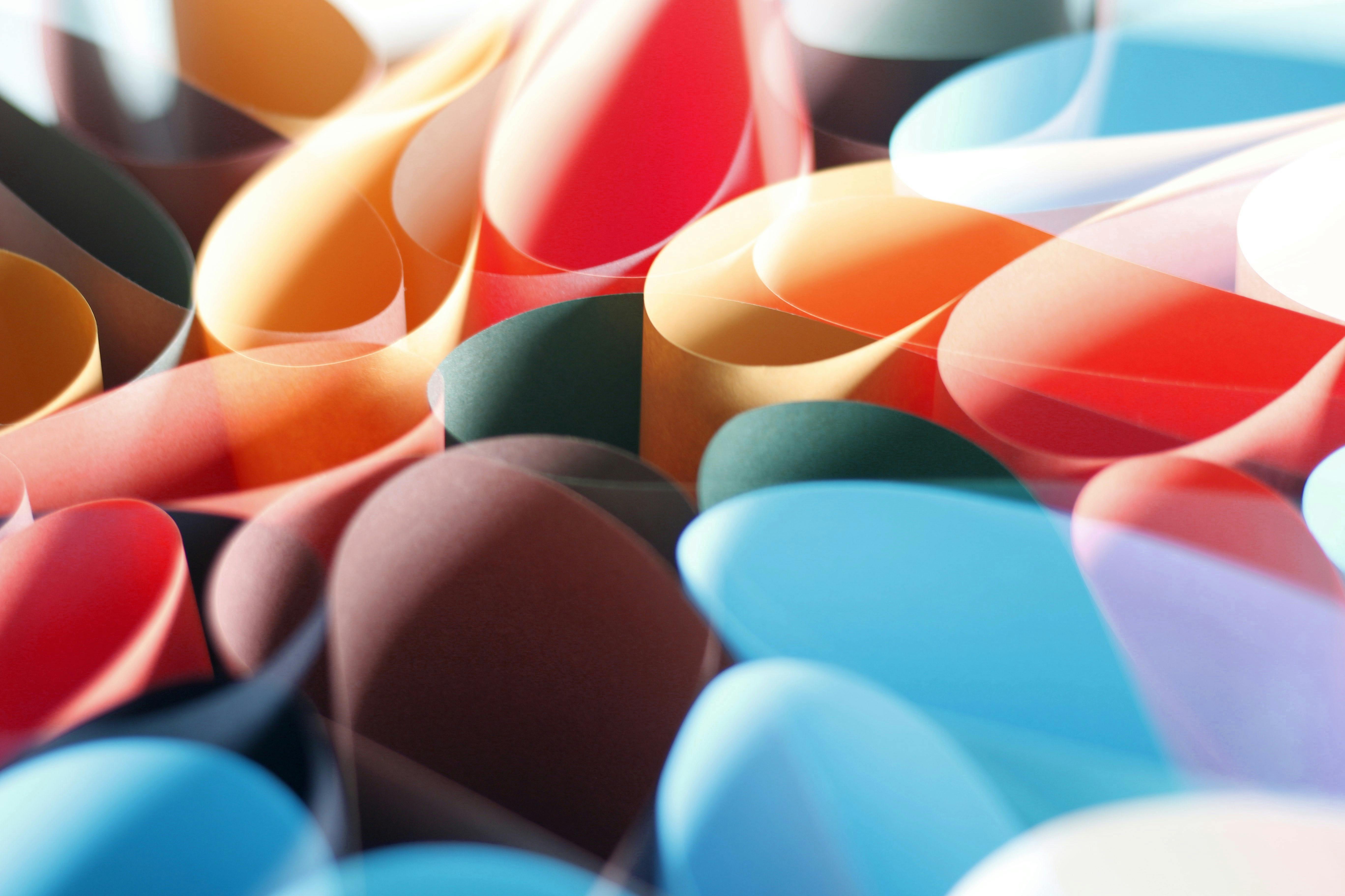 Photo - An abstract photo of a collection of colorful documents or pages that is being used represent resources.